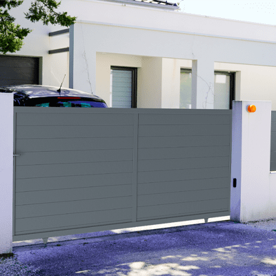 Portail coulissant alu gris à l'entrée d'une maison